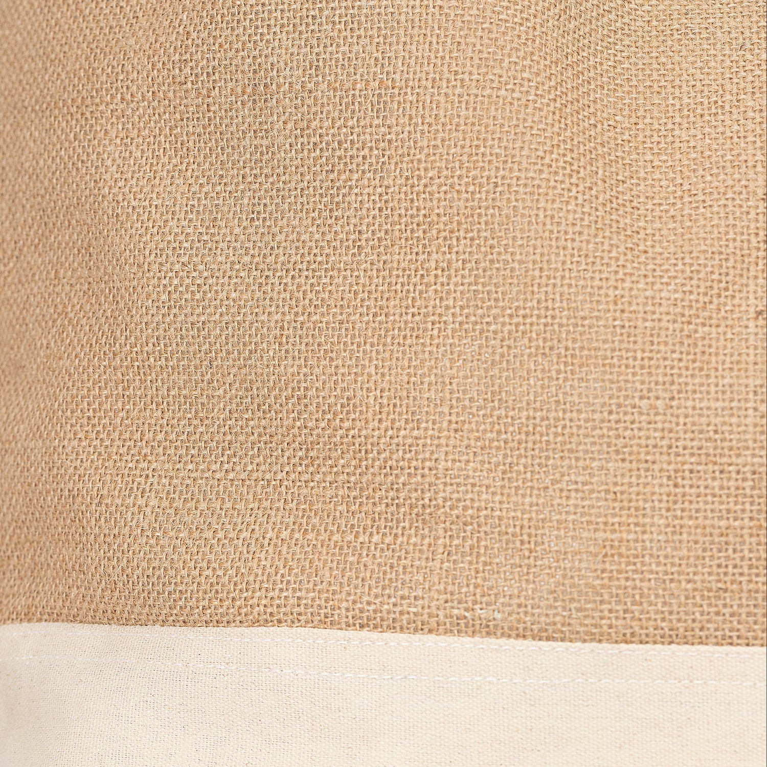 Close-up of a beige fabric product with a visible brand tag on a white background